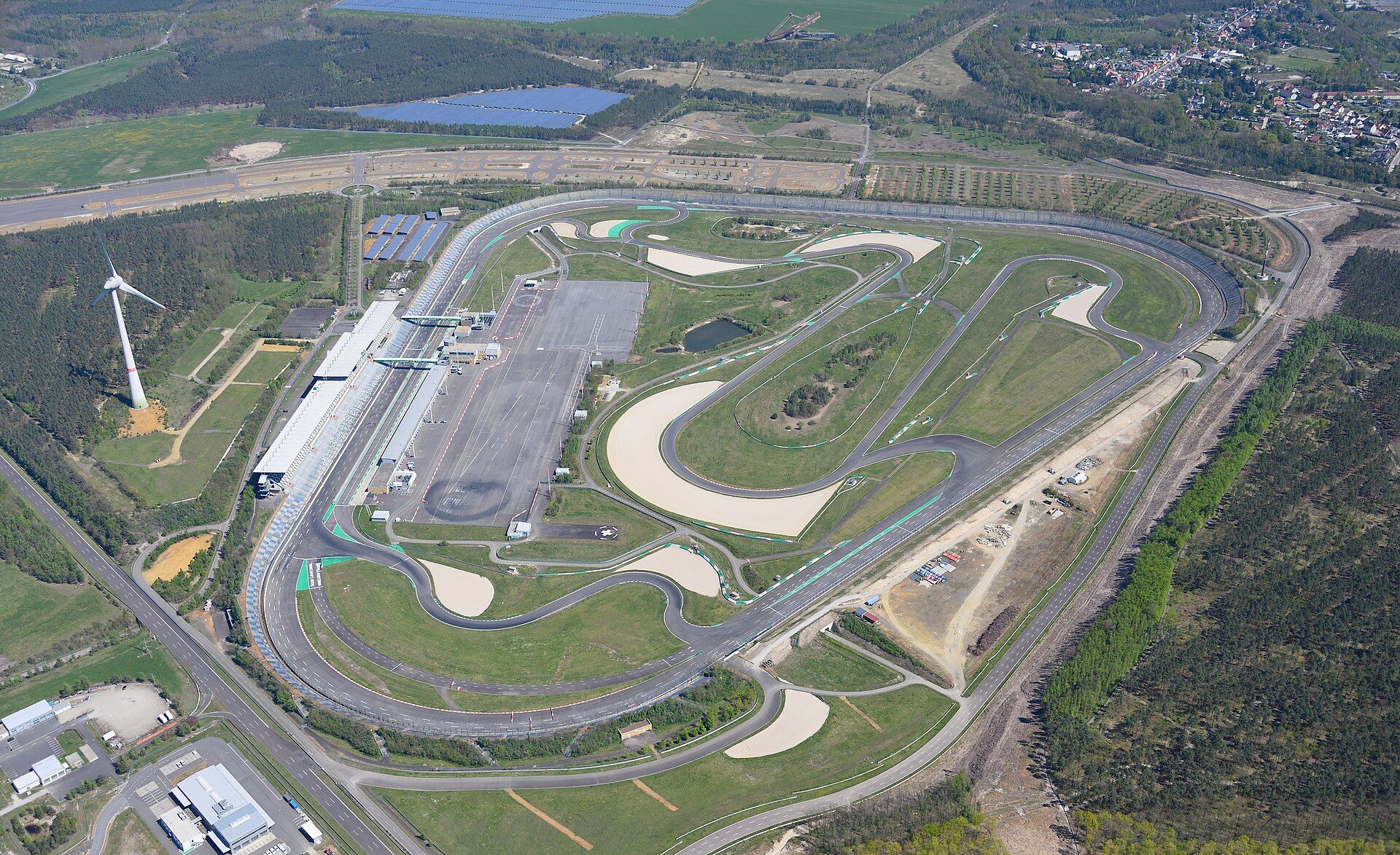 DEKRA Lausitzring from the air, seen from the west: the oval, the infield road-course loops and the pit building