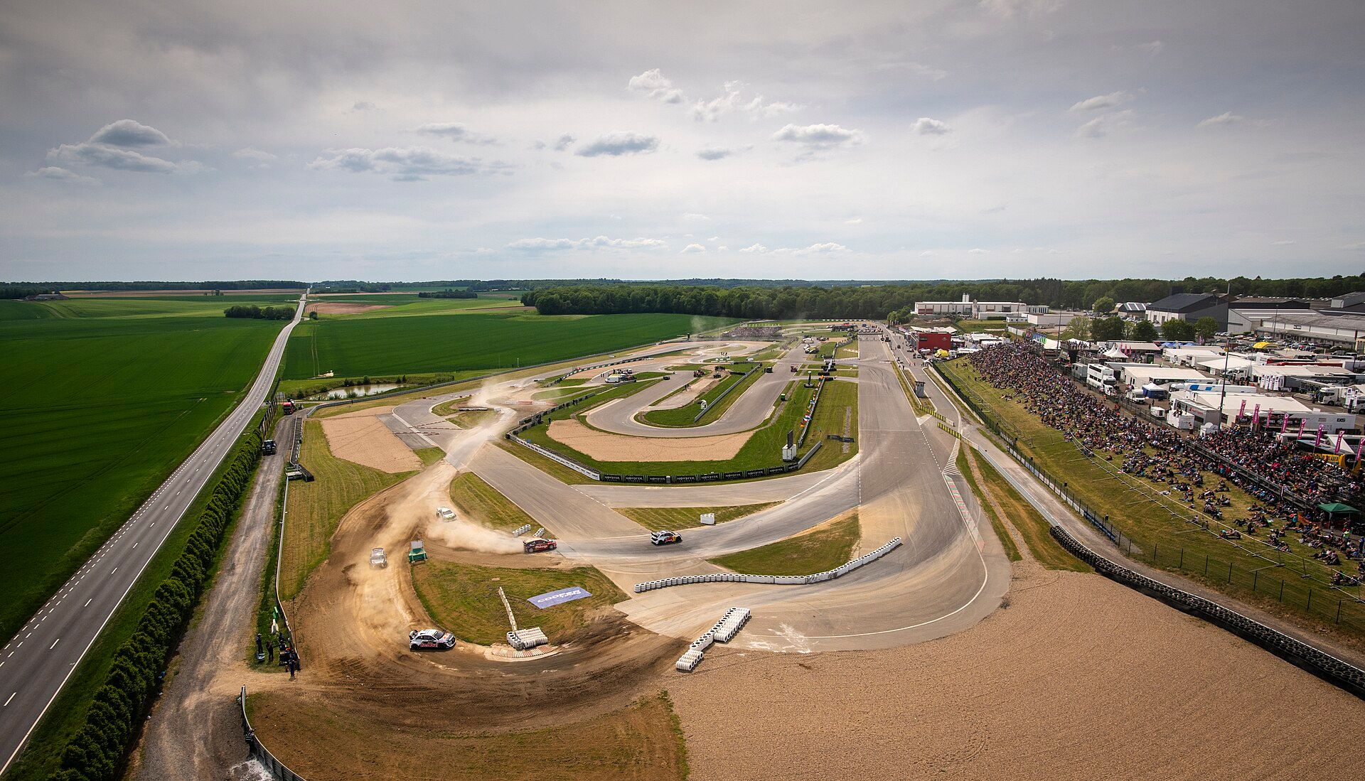 Circuit Jules Tacheny Mettet from the air: the tarmac track with gravel sections, the paddock and spectators on the bank